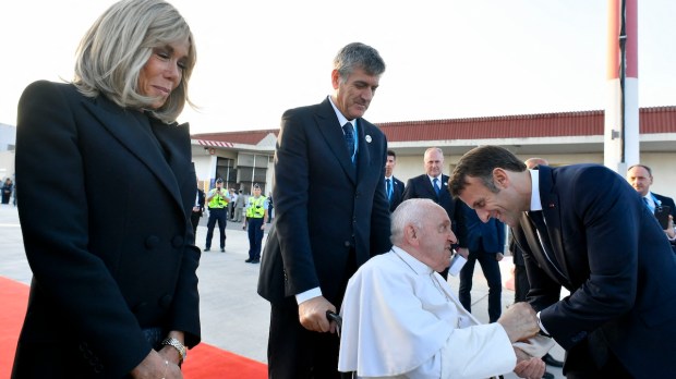French President Macron greets Pope Francis