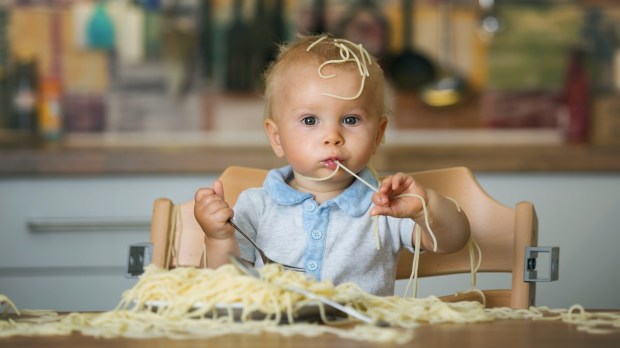 italian baby eating pasta